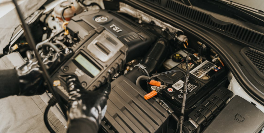 Car Mechanic Inspecting Car Engine